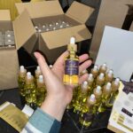 Mell Luxe holding the new batch freshly made for sale of Beard Oil